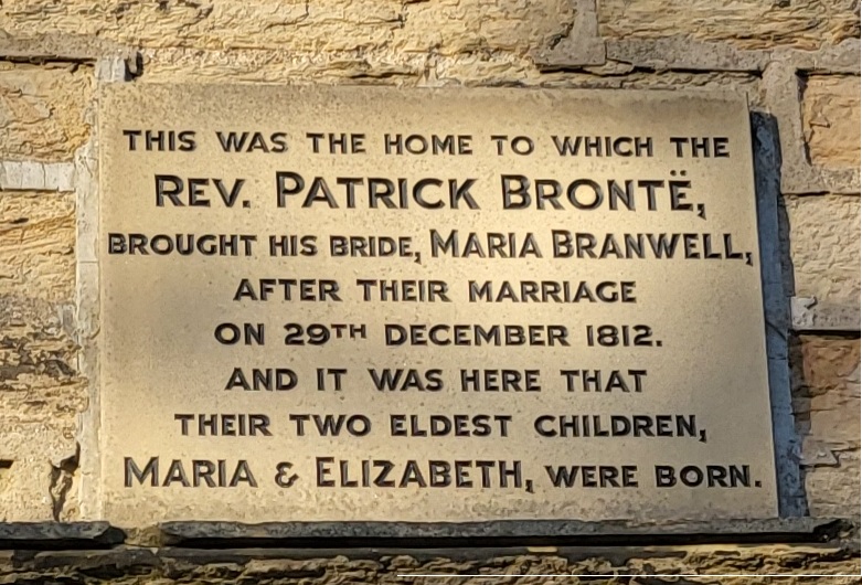 Stone plaque above door at Clough House