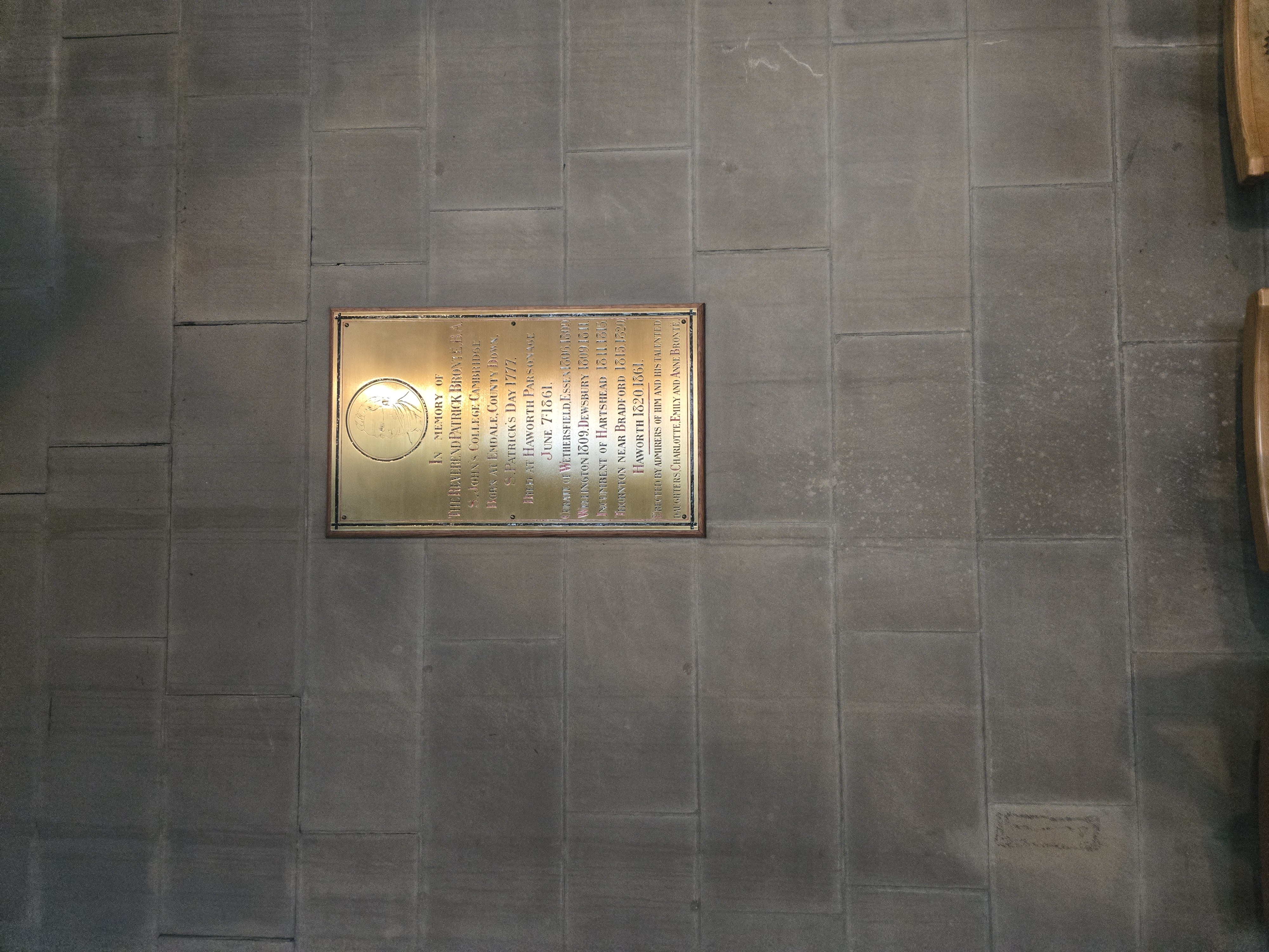 Plaque on stone wall inside church