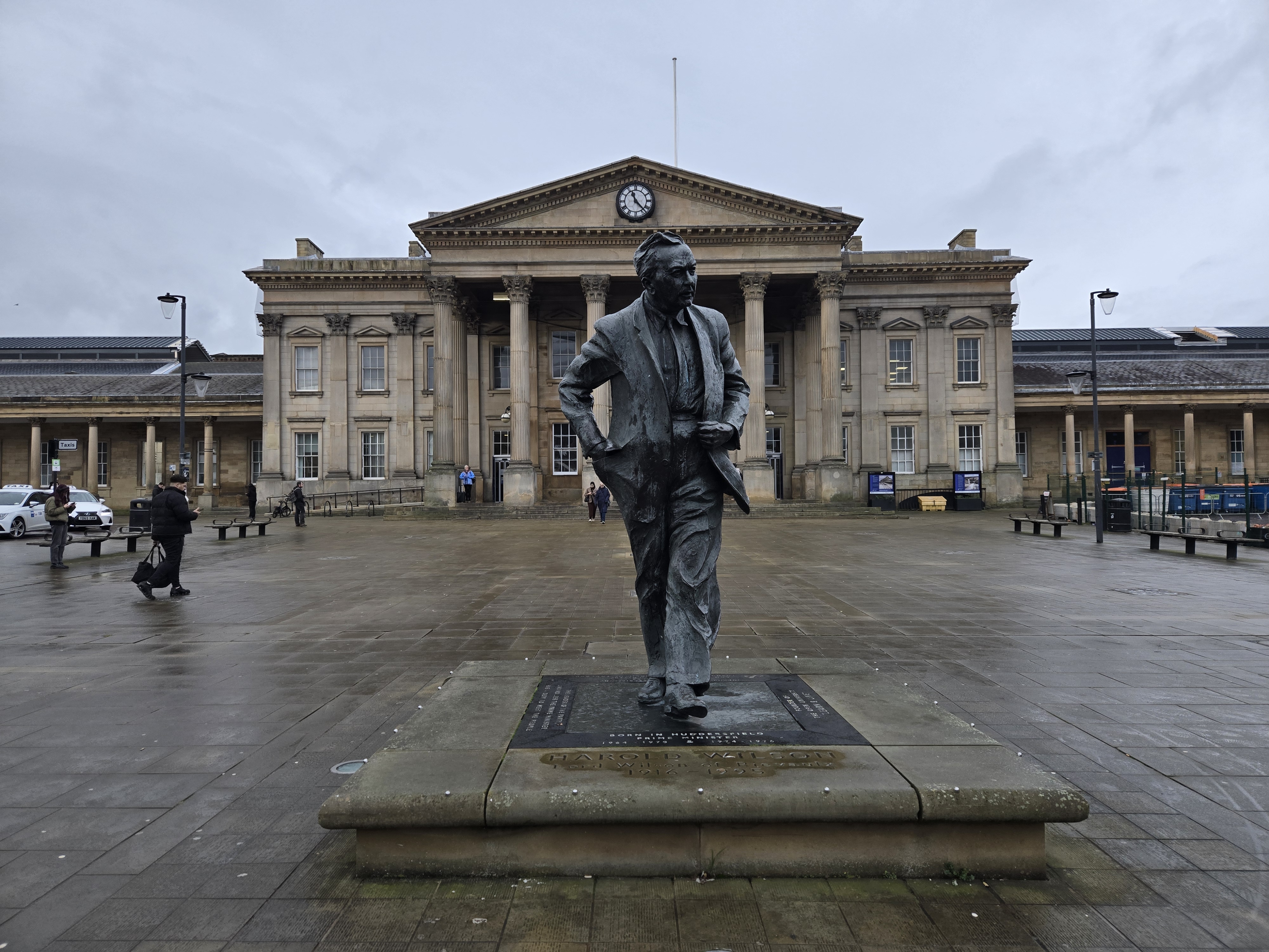 Statue of Sir Harold Wilson in front of Georgian style railway station