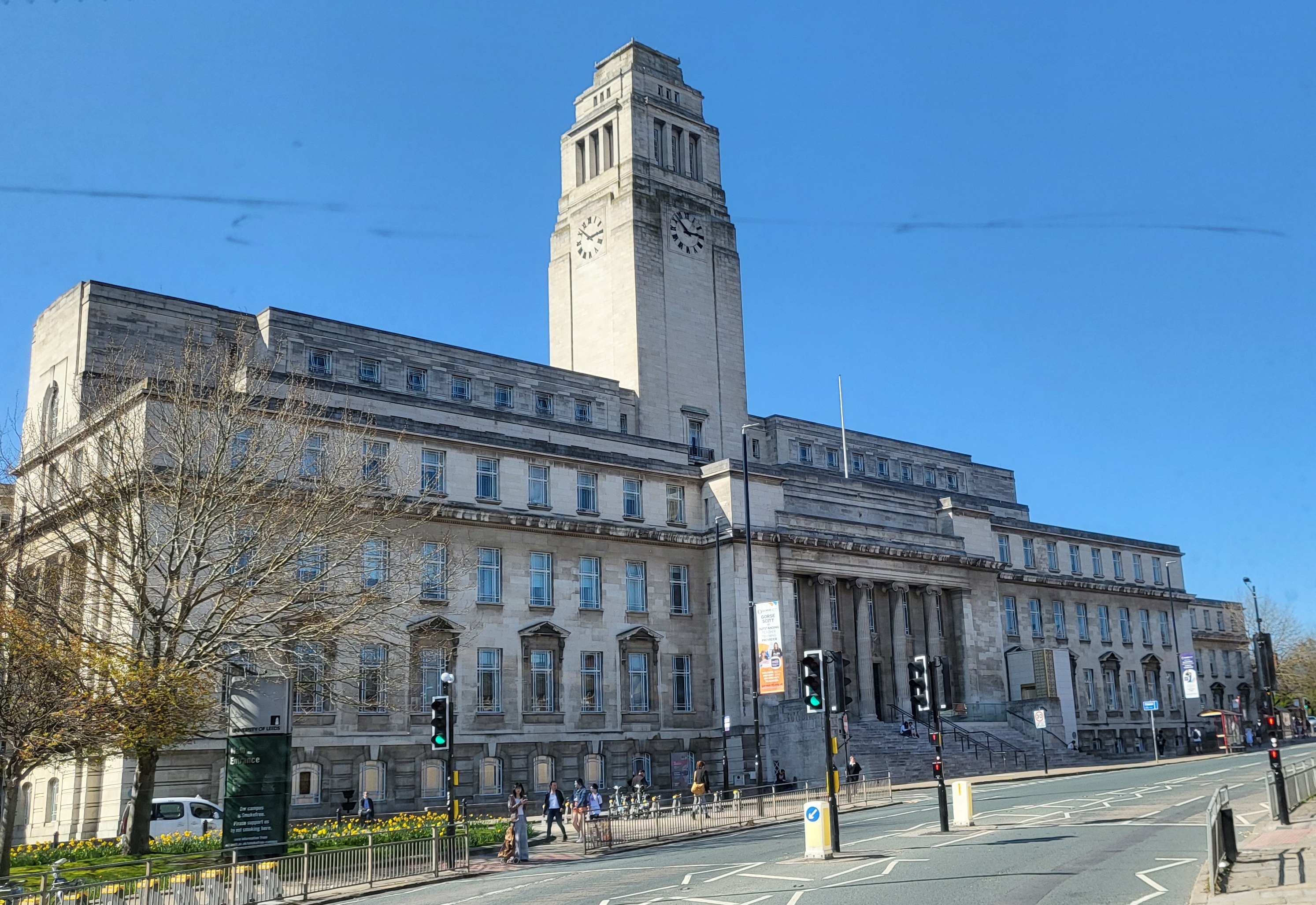White marble building with classical style columns and clock tower