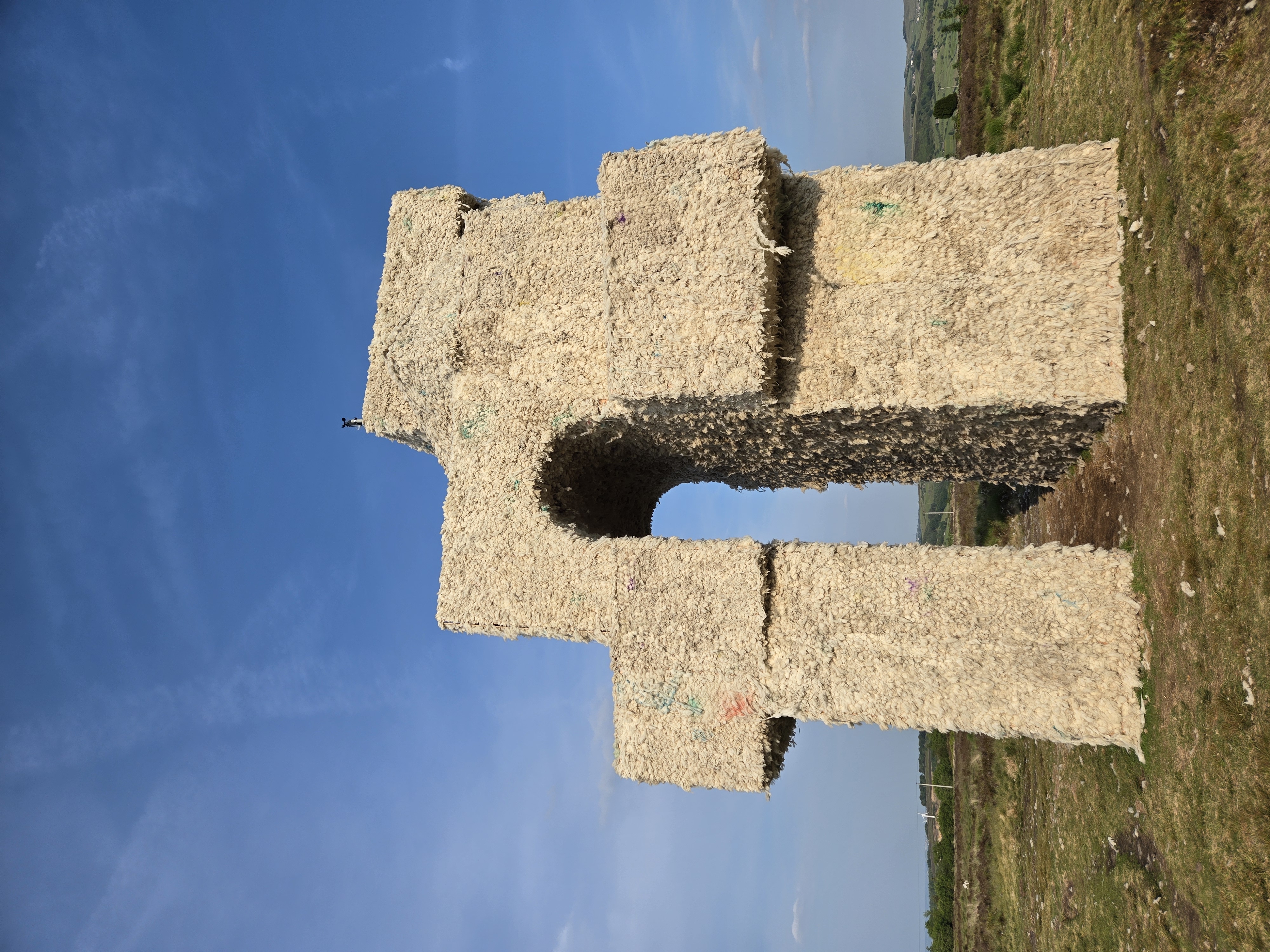 Tower structure clad in bales of hay